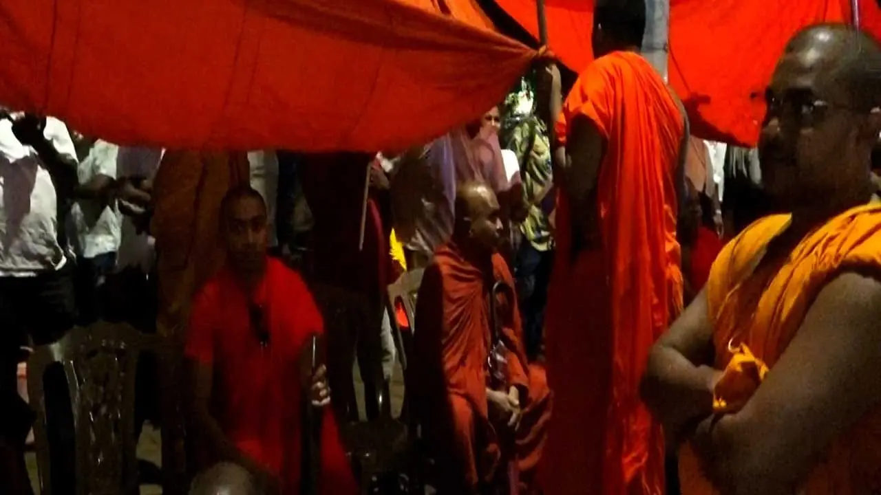 Monks participating in the 'Justice for the Robe' march remain near the Presidential Secretariat.